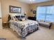 Comfortable bedroom with a blue and white comforter, accent pillows, and black metal bed frame at 8179 Pineview Ct, Villa Rica, GA 30180