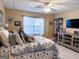 Spacious bedroom featuring neutral walls, a ceiling fan, and a comfortable bed with decorative pillows at 8179 Pineview Ct, Villa Rica, GA 30180