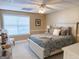 Well-lit bedroom with decorative lamps and a light grey comforter set at 8179 Pineview Ct, Villa Rica, GA 30180