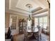 Elegant dining room with coffered ceiling, chandelier, and ample natural light at 8179 Pineview Ct, Villa Rica, GA 30180