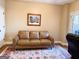 Sitting area with a brown leather couch and rug at 8179 Pineview Ct, Villa Rica, GA 30180