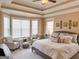 Comfortable main bedroom featuring a bay window, sitting area and a tray ceiling at 8179 Pineview Ct, Villa Rica, GA 30180