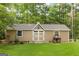 Versatile outbuilding with double doors and windows surrounded by a well-maintained lawn at 8179 Pineview Ct, Villa Rica, GA 30180