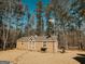 Backyard shed with a gable roof and an American flag at 8179 Pineview Ct, Villa Rica, GA 30180