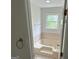 Bathroom featuring soaking tub, towel rack, natural light, and tile flooring at 281 Timber Laurel Ln, Lawrenceville, GA 30043