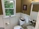 Charming half bathroom featuring white wainscoting and granite countertop at 281 Timber Laurel Ln, Lawrenceville, GA 30043