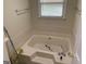 Large soaking tub with tile surround and natural light at 281 Timber Laurel Ln, Lawrenceville, GA 30043