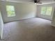 Spacious bedroom with two large windows, ceiling fan, and soft carpeting at 281 Timber Laurel Ln, Lawrenceville, GA 30043