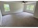 Bedroom with neutral carpet, two windows providing natural light and ceiling fan at 281 Timber Laurel Ln, Lawrenceville, GA 30043