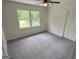 Bedroom featuring neutral paint, a large window, ceiling fan and closet for storage at 281 Timber Laurel Ln, Lawrenceville, GA 30043