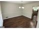 Dining room has modern lighting, wood-look floors, and white trim at 281 Timber Laurel Ln, Lawrenceville, GA 30043
