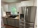 Kitchen featuring stainless refrigerator, butcher block countertops and tile backsplash at 281 Timber Laurel Ln, Lawrenceville, GA 30043