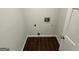 Small laundry room with wood-look tile flooring and white trim at 281 Timber Laurel Ln, Lawrenceville, GA 30043
