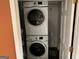 Convenient laundry room featuring stacked washer and dryer units at 281 Timber Laurel Ln, Lawrenceville, GA 30043