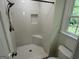 Bathroom featuring a white tiled shower with niche, corner seat and bright natural light from window at 281 Timber Laurel Ln, Lawrenceville, GA 30043