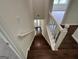 View of wood staircase with white railing and freshly painted walls leading to front door of home at 281 Timber Laurel Ln, Lawrenceville, GA 30043