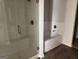 Bathroom featuring glass-enclosed shower and separate soaking tub with tile surround at 1224 Hibiscus Way, Mcdonough, GA 30253