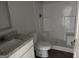 Bathroom featuring a granite-look vanity top, toilet, and enclosed shower with a built-in seat at 1224 Hibiscus Way, Mcdonough, GA 30253