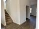 Welcoming entryway with carpeted stairs and wood-look flooring at 1224 Hibiscus Way, Mcdonough, GA 30253