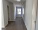 Hallway with neutral carpet, white walls and natural light at 1224 Hibiscus Way, Mcdonough, GA 30253