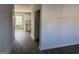 Hallway view into the kitchen, which features white cabinets and stainless steel appliances at 1224 Hibiscus Way, Mcdonough, GA 30253