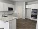 Modern kitchen featuring white cabinets, granite countertops, stainless steel appliances, and wood-look floors at 1224 Hibiscus Way, Mcdonough, GA 30253