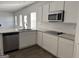 Modern kitchen featuring white cabinets, granite countertops, stainless steel appliances, and wood-look floors at 1224 Hibiscus Way, Mcdonough, GA 30253