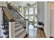 Grand foyer with a staircase, tall windows, and an open view to the living area at 2892 Darlington Run, Duluth, GA 30097