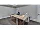 Minimalist home office space featuring a basic desk setup, carpeted floors, and bright, neutral walls at 2892 Darlington Run, Duluth, GA 30097