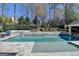 Outdoor pool area with lounge chairs and dining table with a built in hot tub at 2892 Darlington Run, Duluth, GA 30097