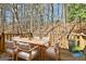 Back deck with outdoor seating, a wooden railing, and surrounding wooded area at 5938 Rock Ct, Union City, GA 30291