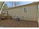 The backyard features wood siding, stairs, a door, a condenser, and lots of leaves at 5938 Rock Ct, Union City, GA 30291