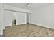 Spacious bedroom with attached bathroom and wood-look flooring features ceiling fan at 5938 Rock Ct, Union City, GA 30291
