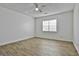 Spacious bedroom featuring wood-look flooring, a ceiling fan, and natural light at 5938 Rock Ct, Union City, GA 30291