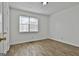 Bright bedroom features wood-look flooring and a window letting in natural light at 5938 Rock Ct, Union City, GA 30291