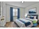 This bedroom features a comfy bed with blue accents, light walls and wood flooring at 5938 Rock Ct, Union City, GA 30291