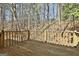 Empty wooden deck in need of repairs overlooking wooded property with a wooden rail and no furnishings at 5938 Rock Ct, Union City, GA 30291