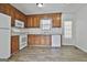 Well-lit kitchen featuring wood cabinets and white appliances providing function and style at 5938 Rock Ct, Union City, GA 30291