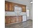 Functional kitchen with wood cabinets, laminate countertops, and updated flooring at 5938 Rock Ct, Union City, GA 30291