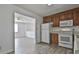 Bright eat-in kitchen featuring white appliances and wood cabinets providing a cozy space at 5938 Rock Ct, Union City, GA 30291