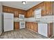 Charming kitchen with ample counter space, wooden cabinetry, and modern white appliances at 5938 Rock Ct, Union City, GA 30291