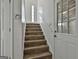 Staircase features wood-look stairs and white railing leading to an exterior door at 5938 Rock Ct, Union City, GA 30291