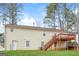 Back exterior view of house with stairway to deck and large lawn at 117 Parkway Ct, Dallas, GA 30157