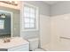 Bright bathroom featuring white cabinets, a large mirror, and a shower-tub combo at 117 Parkway Ct, Dallas, GA 30157