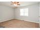 Neutral-toned bedroom featuring a ceiling fan, carpeted floors, and natural light from a window at 117 Parkway Ct, Dallas, GA 30157