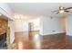 Living room flows to the kitchen, offering hardwood floors and a stone fireplace at 117 Parkway Ct, Dallas, GA 30157