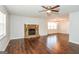 Spacious living room featuring beautiful hardwood floors and a stone fireplace at 117 Parkway Ct, Dallas, GA 30157