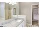Bright bathroom featuring a single vanity with granite countertop, a large mirror, and a shower with sliding doors at 495 N Oakland Cir, Mcdonough, GA 30253