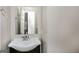 Neutral bathroom with a single vanity with chrome faucet and dark wood cabinet at 495 N Oakland Cir, Mcdonough, GA 30253
