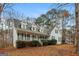 Inviting two-story home with a green roof and shutters, complemented by a well-manicured lawn and front porch at 495 N Oakland Cir, Mcdonough, GA 30253